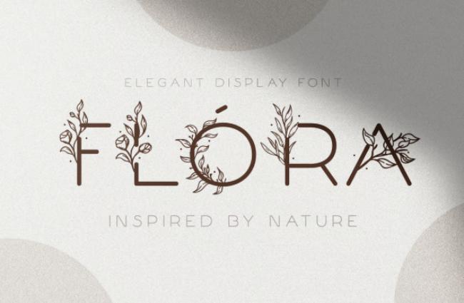 Flora delicate floral font featuring refined letters with subtle flower decorations and elegant botanical details